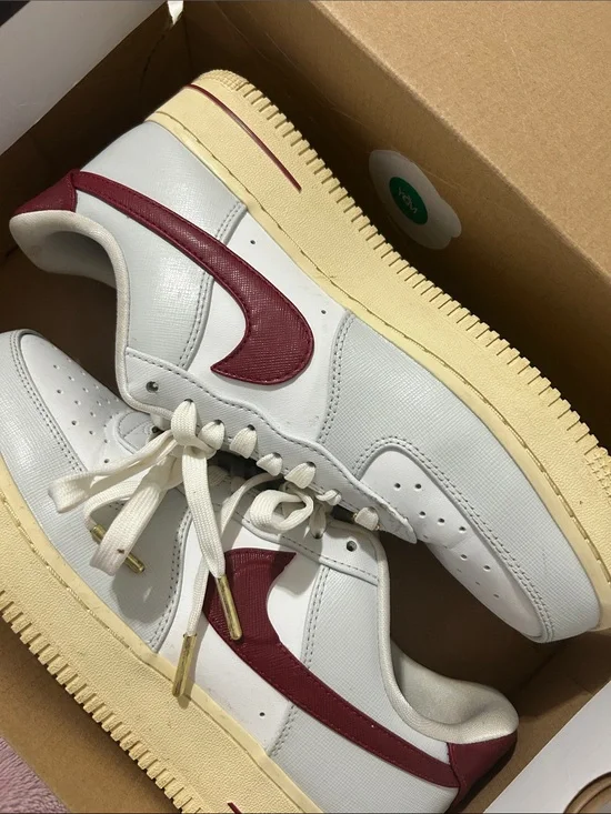 Nike White Sneakers with Burgundy Swoosh and Cream Sole