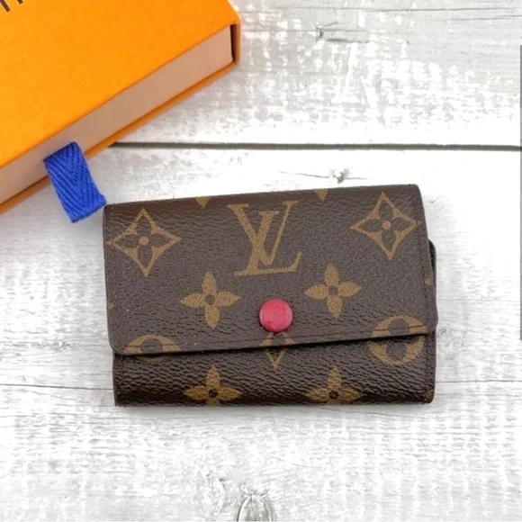 AUTHENTIC Louis Vuitton key holder. Monogram pattern. Magenta interior.