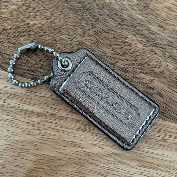 Metallic silver - Coach Stamped Leather Hang Tag