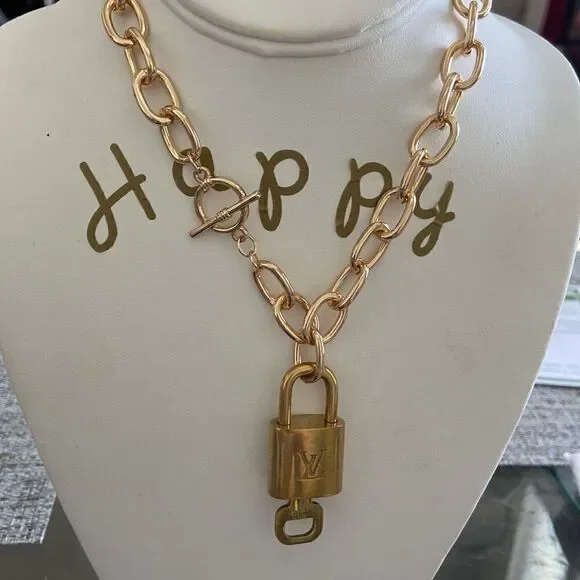 LV key lock with key 100% authentic with NWT necklace