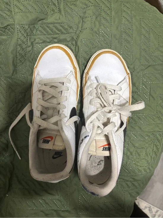 Nike White Leather Sneakers with Black Swoosh and Yellow Accent