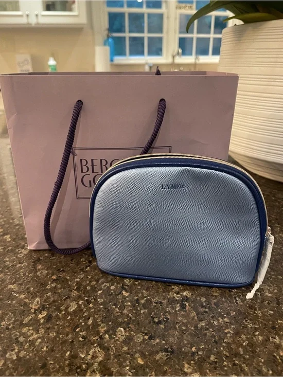 La Mer Light Blue Cosmetic Pouch with Bergdorf Goodman shopping bag