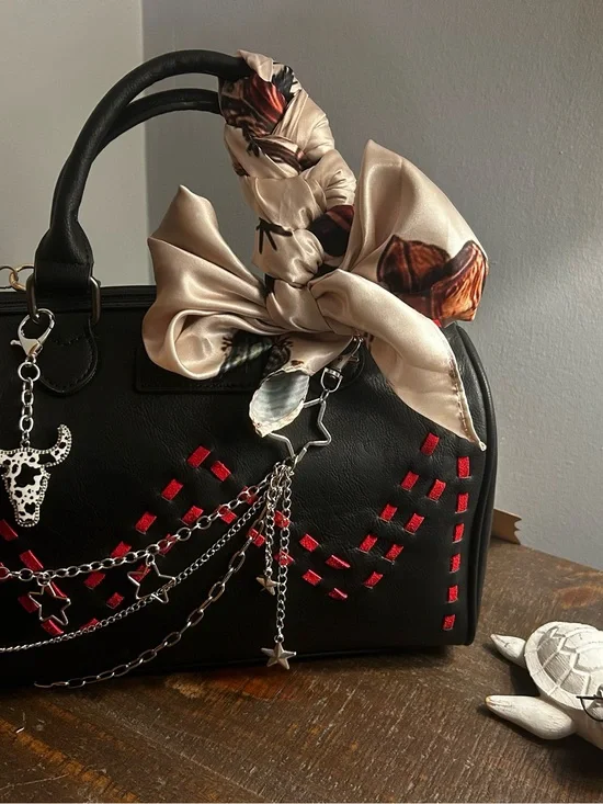 Black Satchel Handbag with Red Accents and Cream Bow