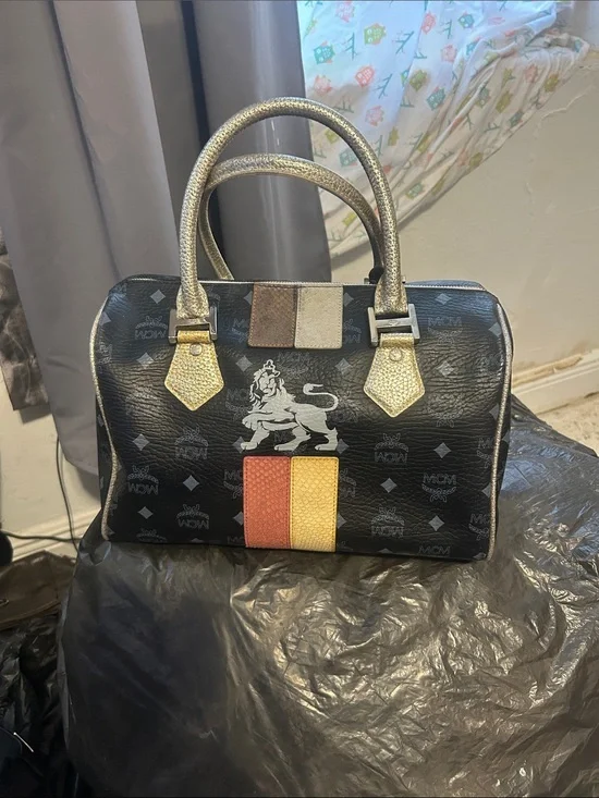 Lion 🦁 Black Logo Satchel with Red and Yellow Stripe and Gold Handles