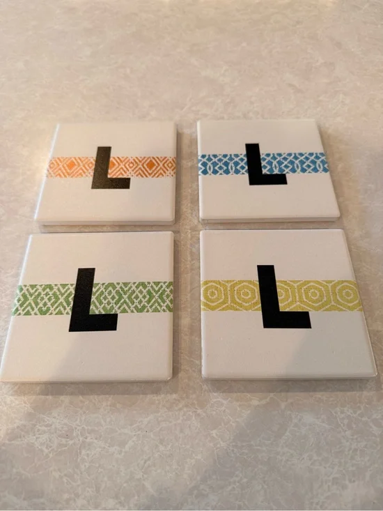Food Network White Coasters with Black L and Orange, Blue, Green, Yellow Bands