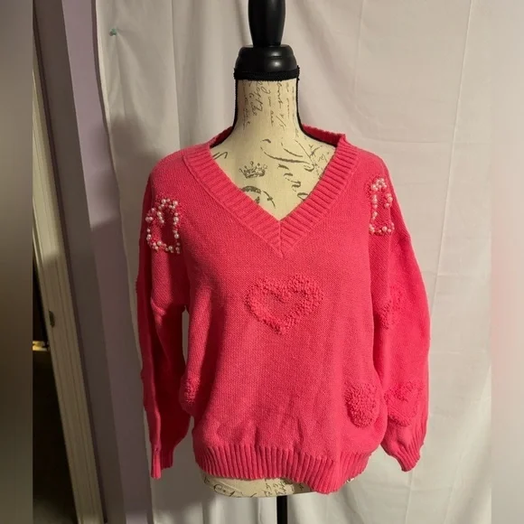 Boutique women’s pink sweater with hearts