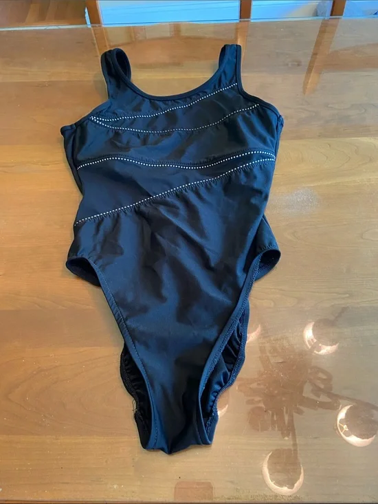 Miracle suit.  One-Piece Swimsuit with Subtle Dot Trim and Criss-Cross front. 10