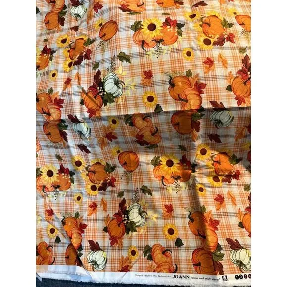 Joanne Fabrics harvest-themed pumpkins and sunflowers on a plaid background