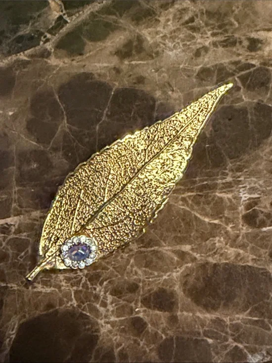 Beautiful gold plated leaf with a cabochon opal and crystal surrounding