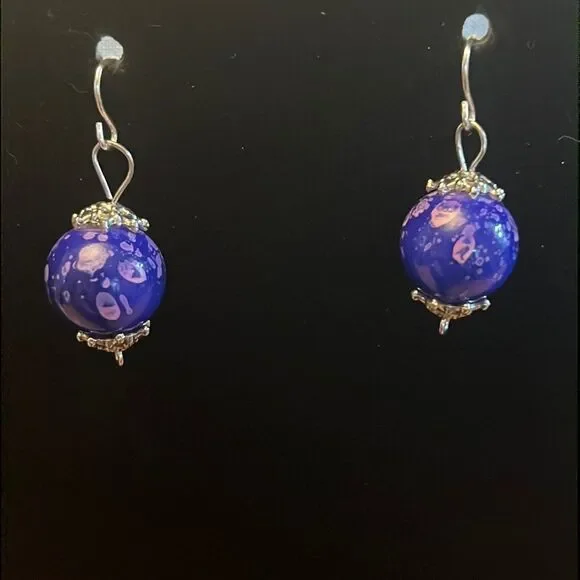 Handcrafted purple and silver tone earrings.