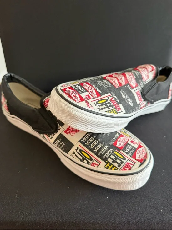Vans Slip-On Sneakers in Black, White & Red Logo Print