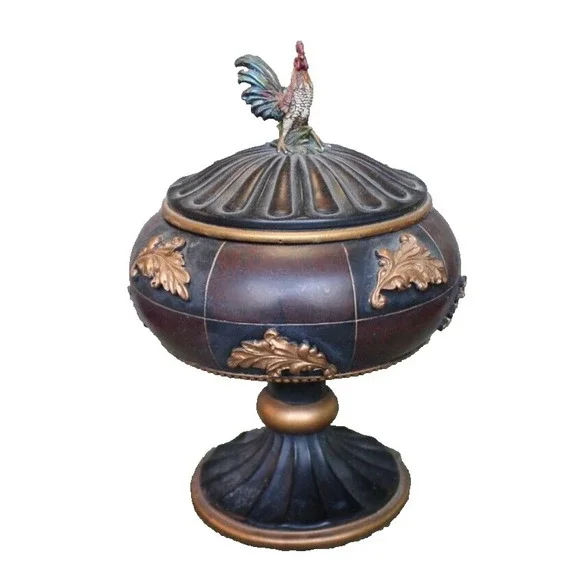Notions container in form of large lidded pedestal cup with rooster on top
