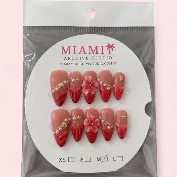 red and pink floral press-on nails with gold stars and pearls