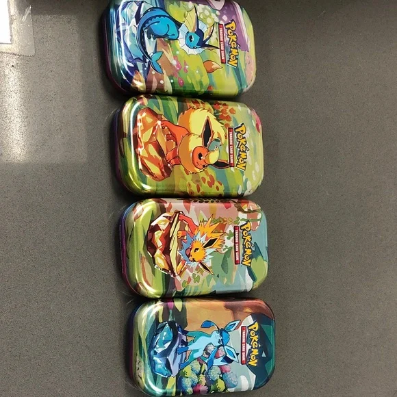 Pokemon Eevee and Evolutions Tin Set - Blue, Green, Orange, Purple