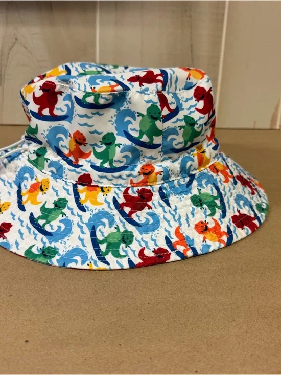 Amazon Kids' White Bucket Hat with Multicolor Surfing Dinosaurs