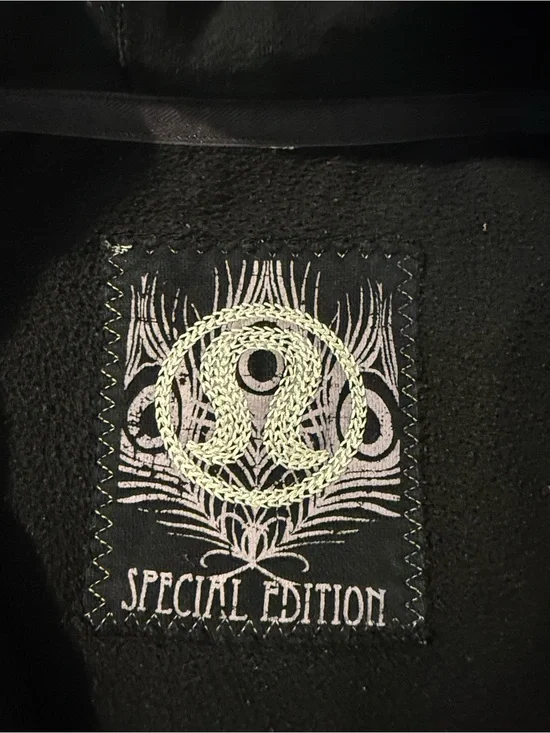 lululemon athletica. Special edition.  black jacket with ruffle trim and hood.