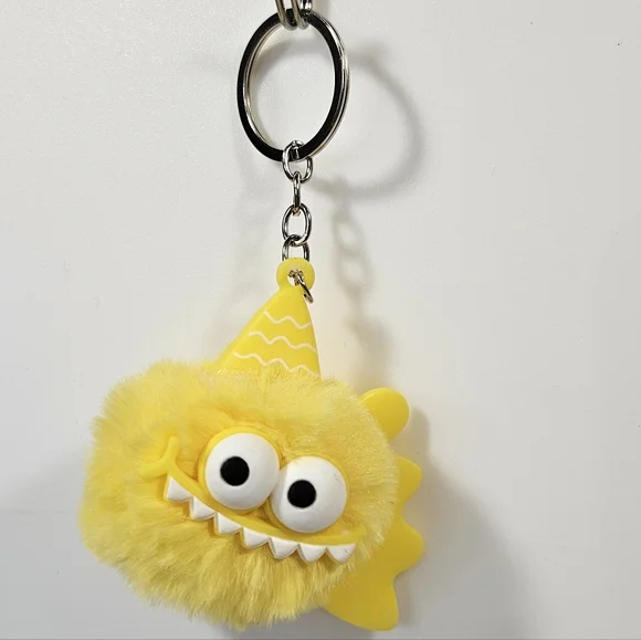 Yellow Monster Puff Keychain – Cute Fuzzy Charm with Party Hat