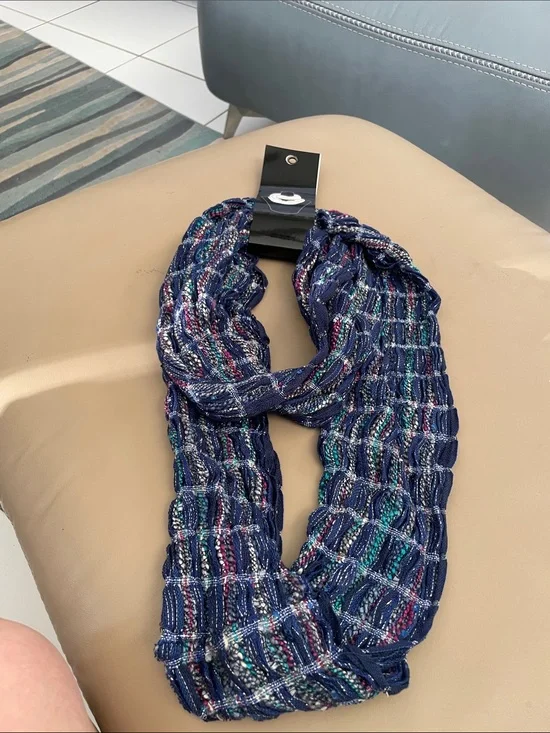 Infinity scarf new in package. Colors blue, red teal and silver. Great accent to
