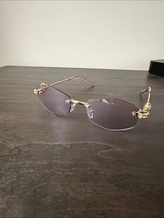 Elegant Rimless Women's Sunglasses with Gold Accents - Purple Lenses