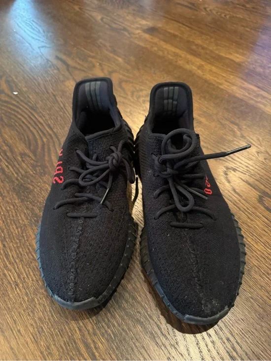 Black Yeezy 350 sneakers with red text