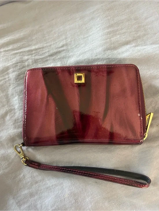 Hard to find patterned Patent Purple Wristlet Wallet with Gold Tone Hardware.