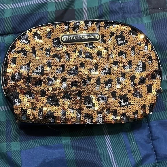 Betsey Johnston gold and black sequined  cosmetic bag. Good condition
