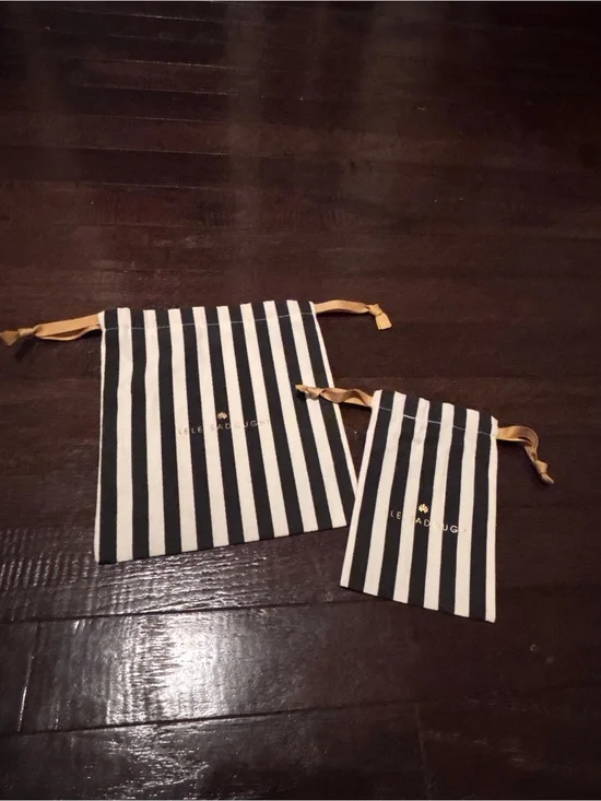 Lele Sadoughi Black and White Striped Drawstring Pouches with Gold Logo
