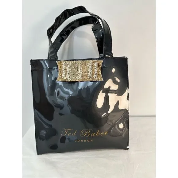 Ted Baker London Icon vinyl handbag with gold bow.    M-0927