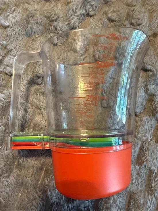 Pampered ChefMeasuring Cup Base and Multi-Color Nesting Spoons