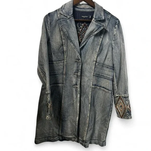 Blue denim jacket with embroidered sleeves,‎ featuring a boho western vibe