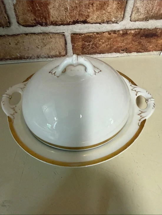 A Haviland & Co. Limoges porcelain covered tureen with gold trim. Butter Dish.