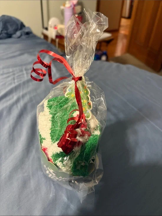 Holiday Green & White Decorative sock cupcake decorated with bow.