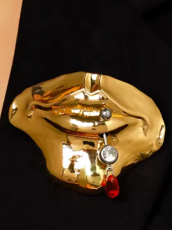 Gold Tone Lip-Shaped Brooch with Red Teardrop Charm