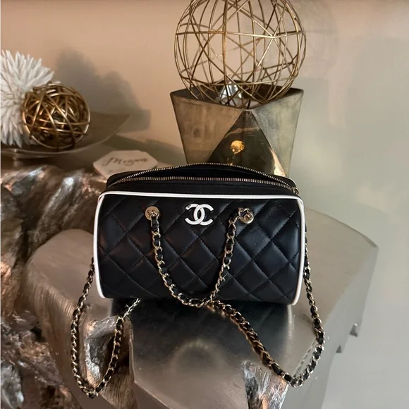 CHANEL Black Quilted Shoulder Bag with White Trim and Silver Hardware