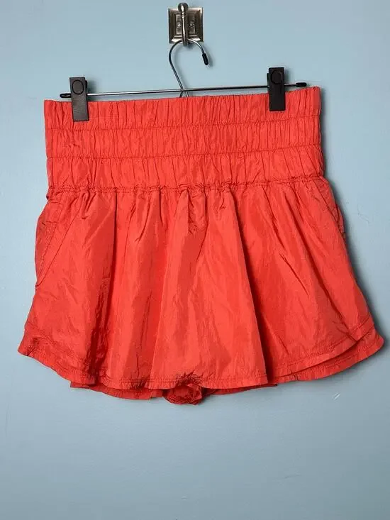 Free People FP Movement Way Home shorts in a vibrant coral reddish-orange color