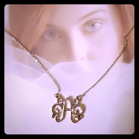 Boutique item, silver tone initial 