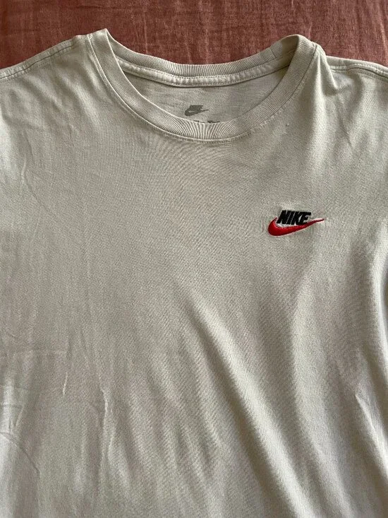 The Nike Tee With Two Red and Black Embroidered Logo - Size S