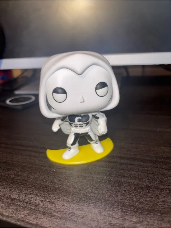 White and Black Superhero Vinyl Figure on Yellow Base