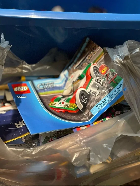 Big Tub full of Legos with a bag full of  Different Guide Books!