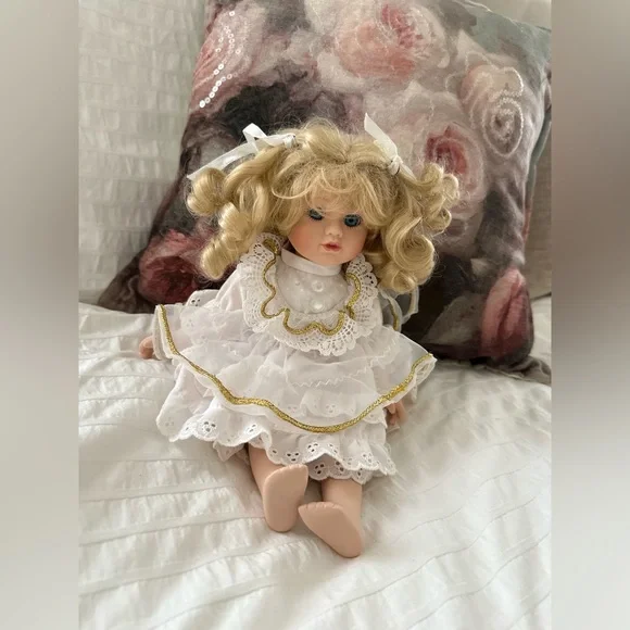 Victorian style porcelain doll with curly blond hair