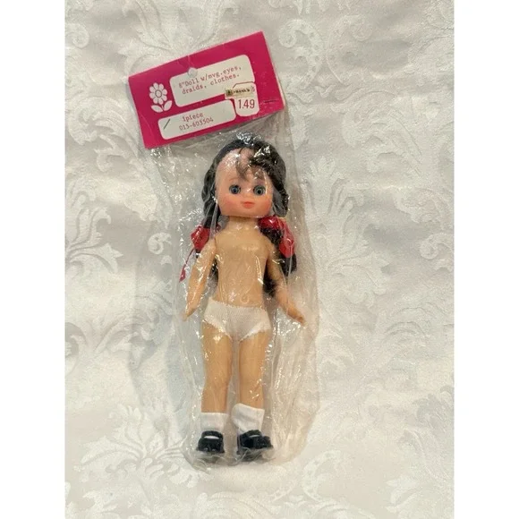 vintage 8-inch doll from Frank's with movable eyes, braids, and white panties.