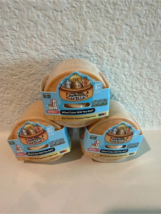 RMS Beauty Mini Metallic Mystery Squishy Pods in Peach and Light Blue Packaging