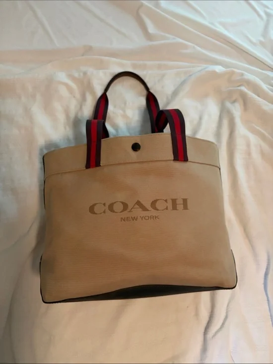 Coach 38” Canvas Duffel Tote in Tan with Red-Trim Handles with original tag.