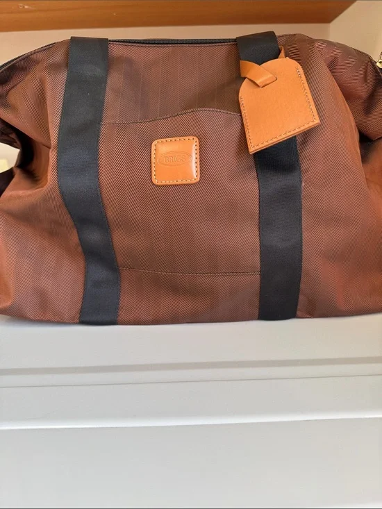 Bric's Brown Duffel Bag with Black Straps and Tan Leather Tag