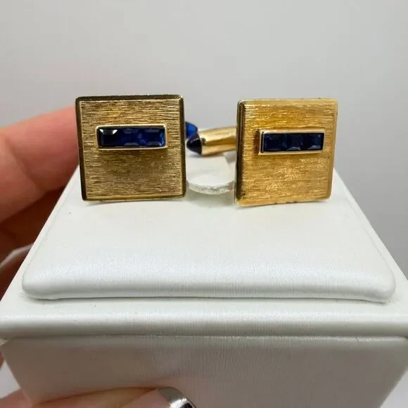 Vintage Krementz Gold tone cuff likes with princess cut blue rhinestone accents!